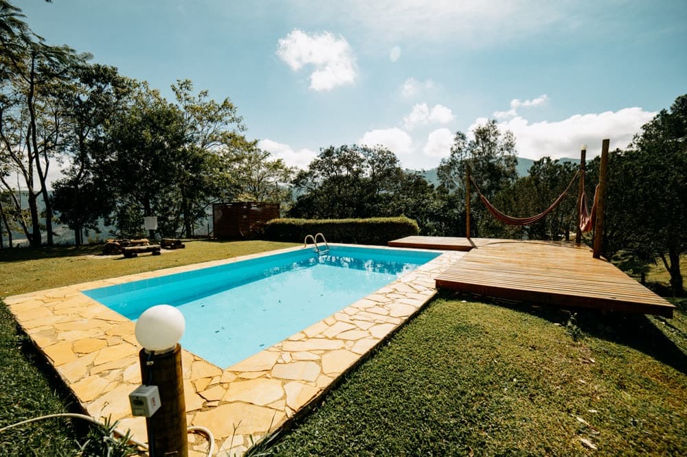 Pool with wooden deck and hammock